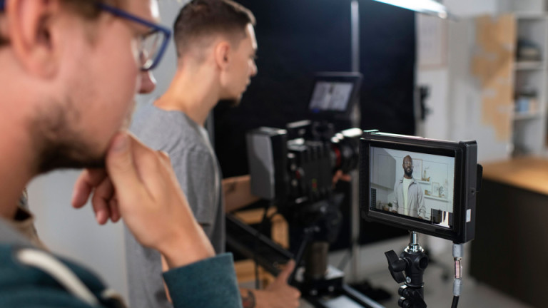 videographers watching a scene unfold on camera