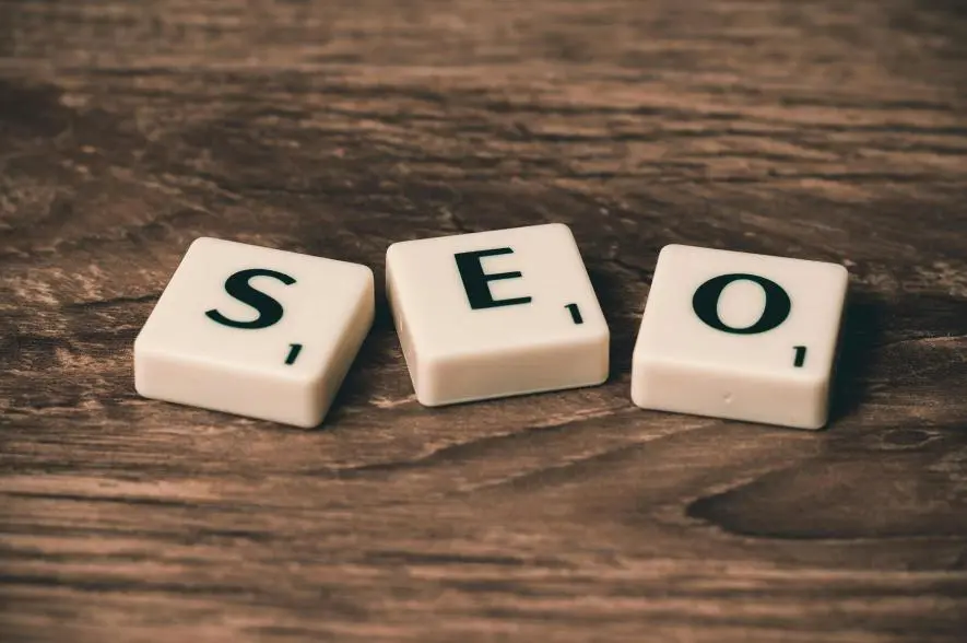 Tiles spelling out SEO on a dark background